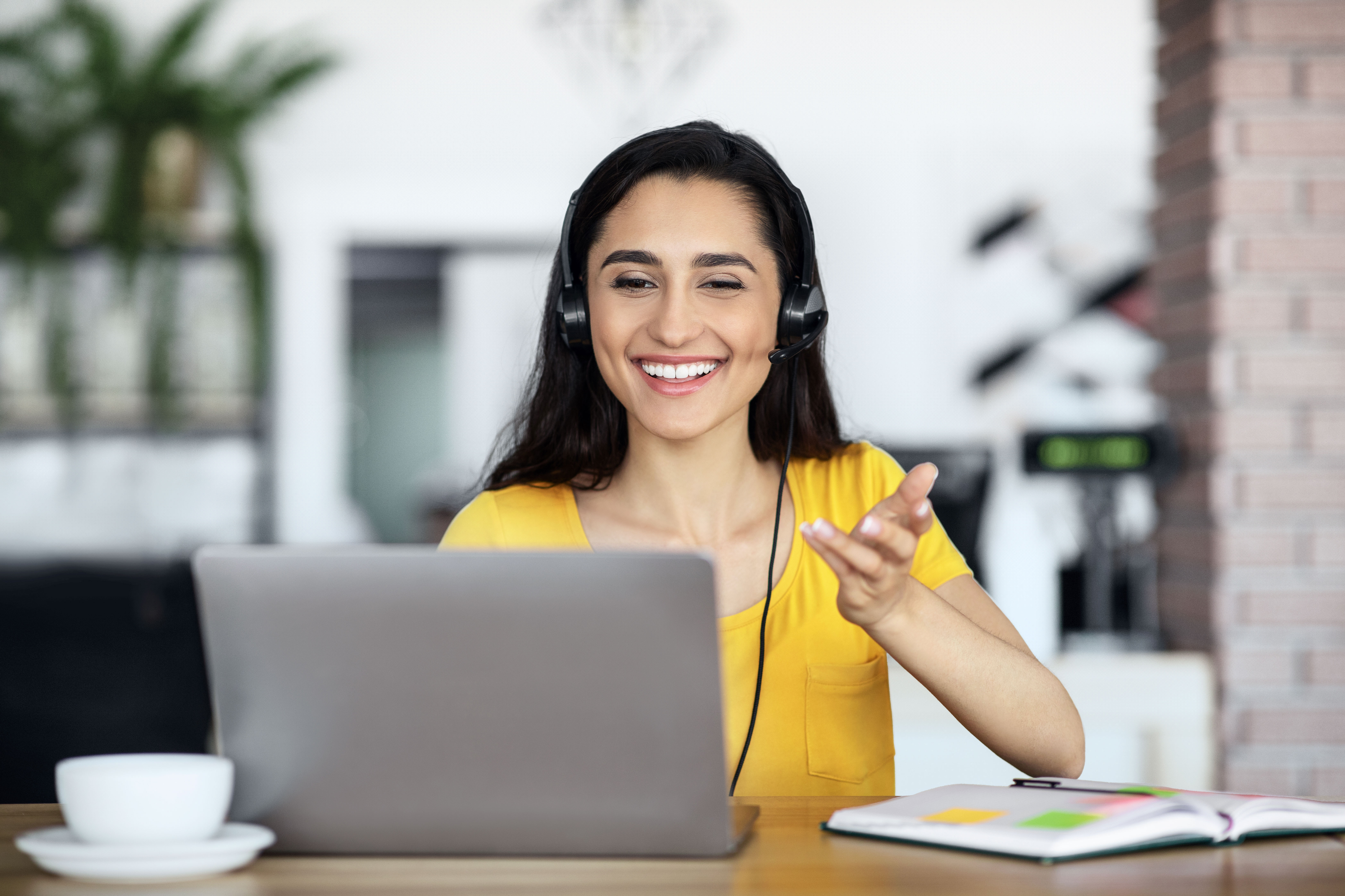A smiling TinyEYE therapist in an online session